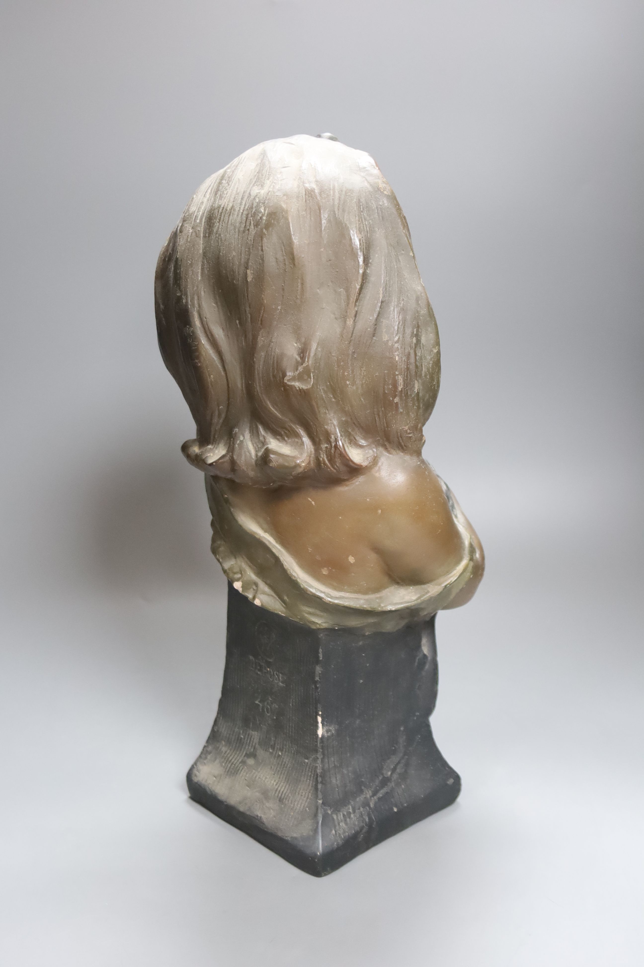 A plaster bust of a girl holding a cat, stamped CM, numbered 467, height 41cm